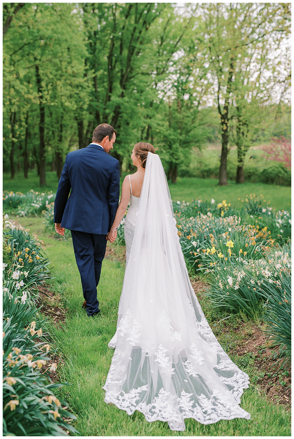bride and groom walking away, veil shot