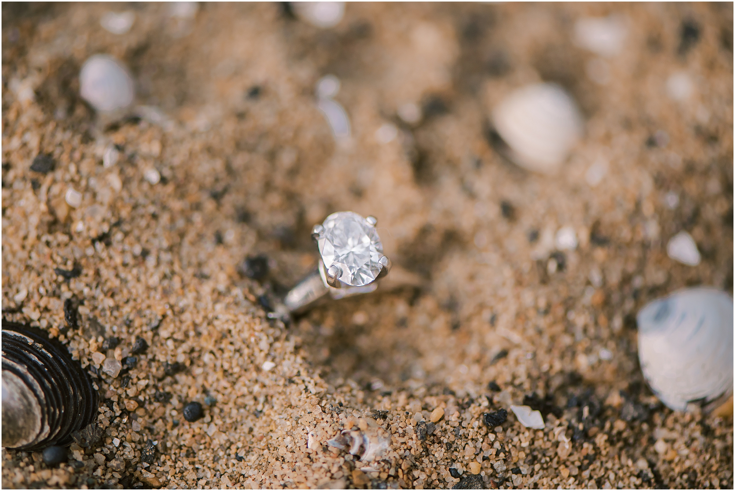 Oval cut engagement ring in sand