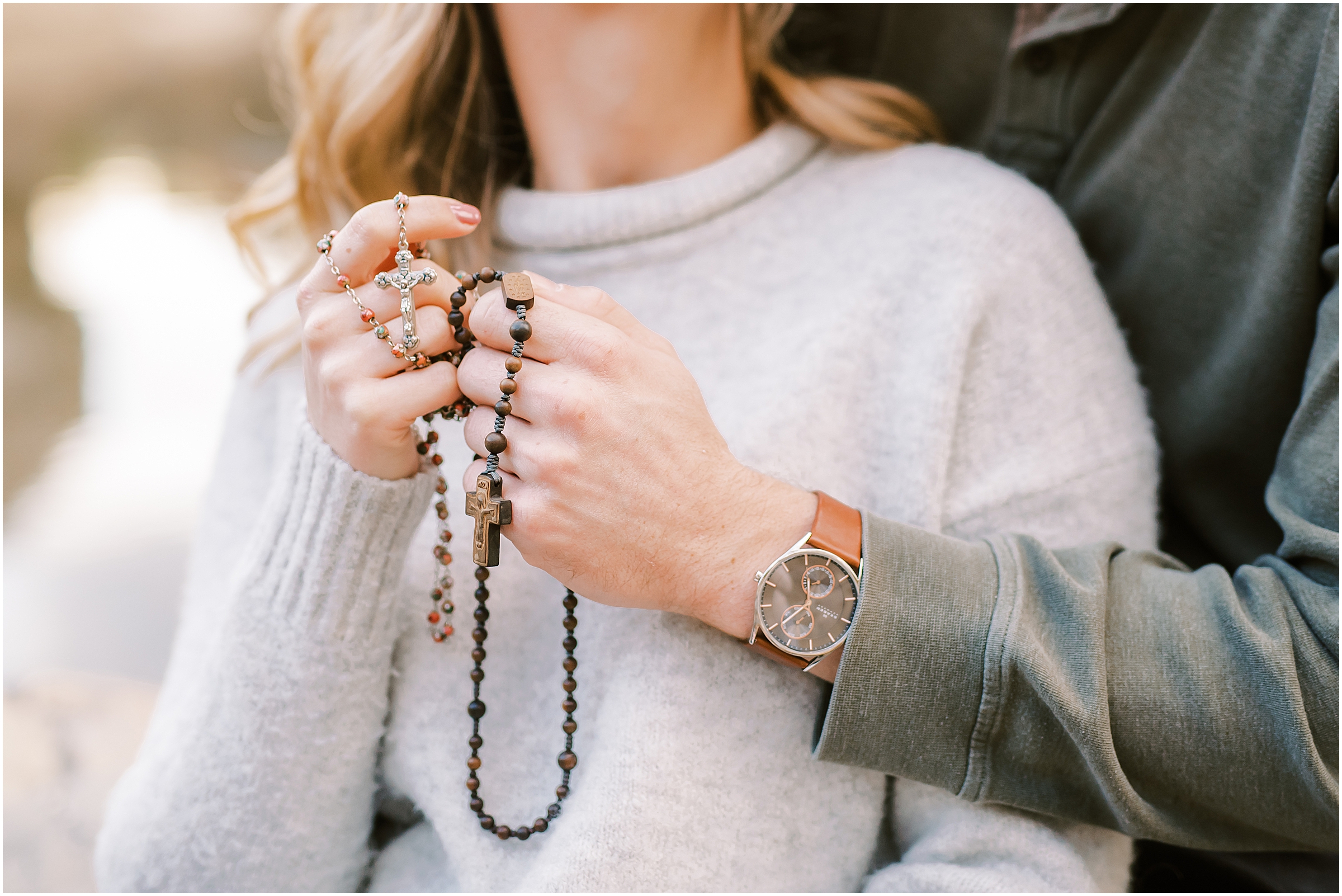 Couple holding rosary in hands