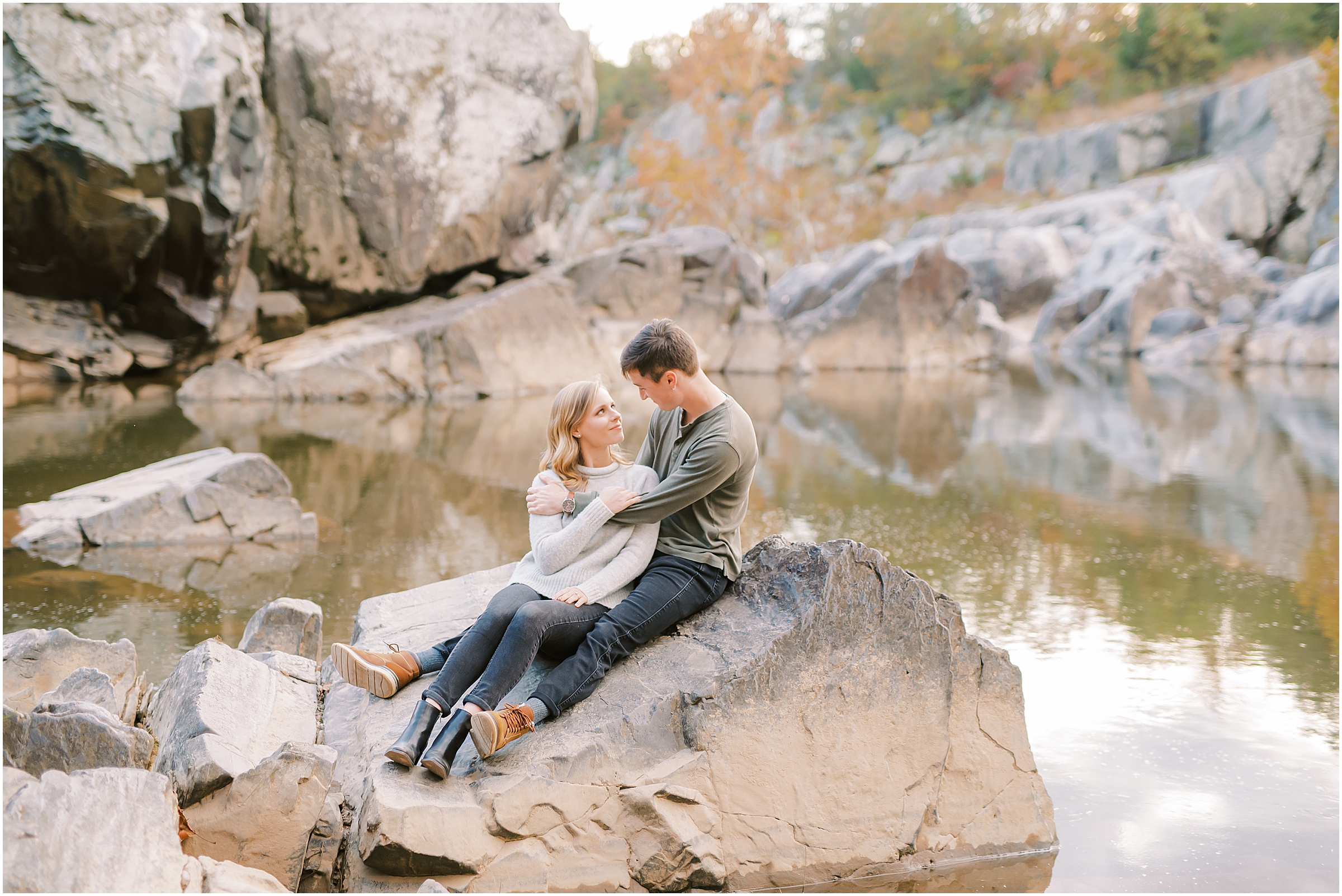 Couple posing on rocks autumn engagement session at Great Falls