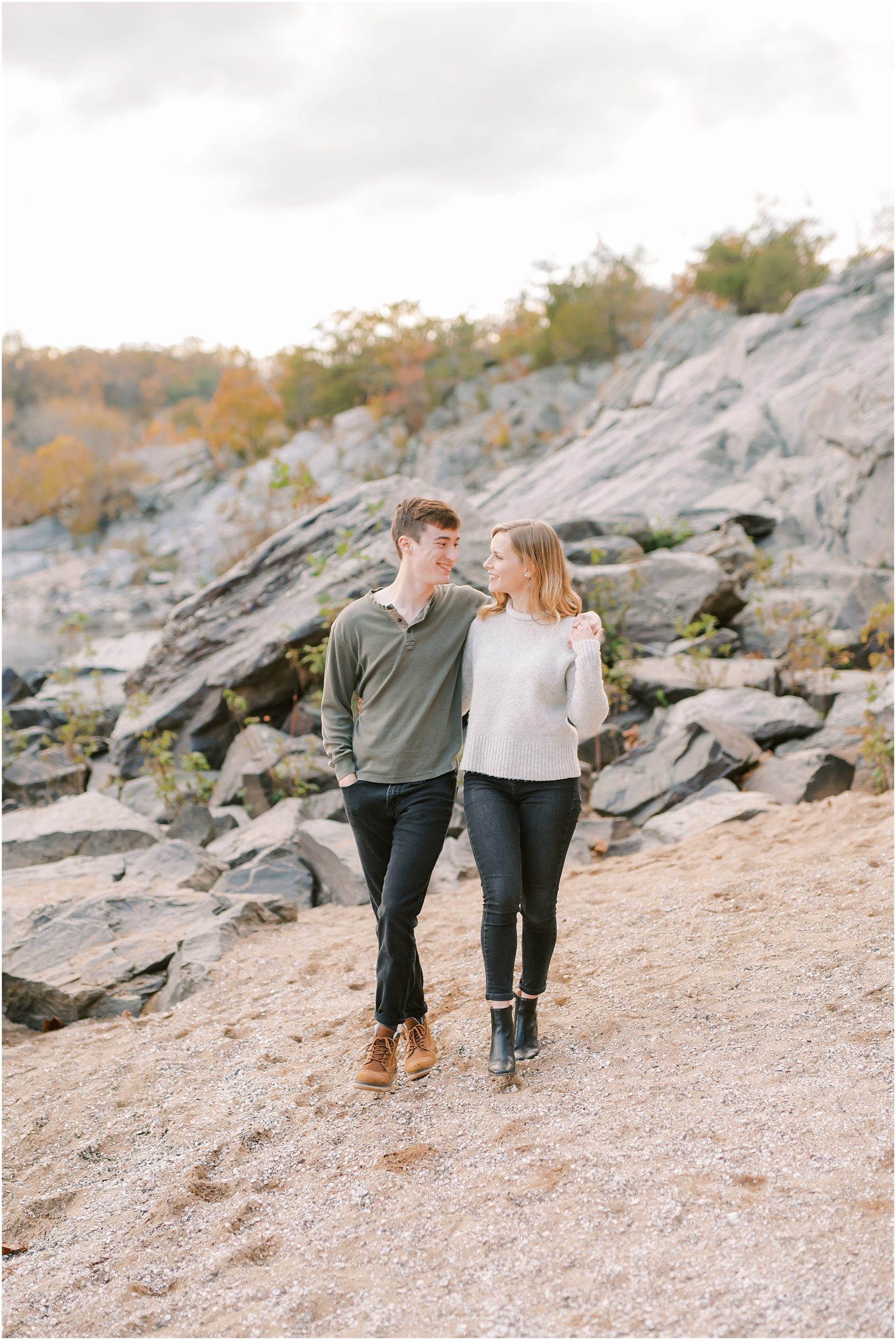 Couple walking in front of rocks at Great Falls Park