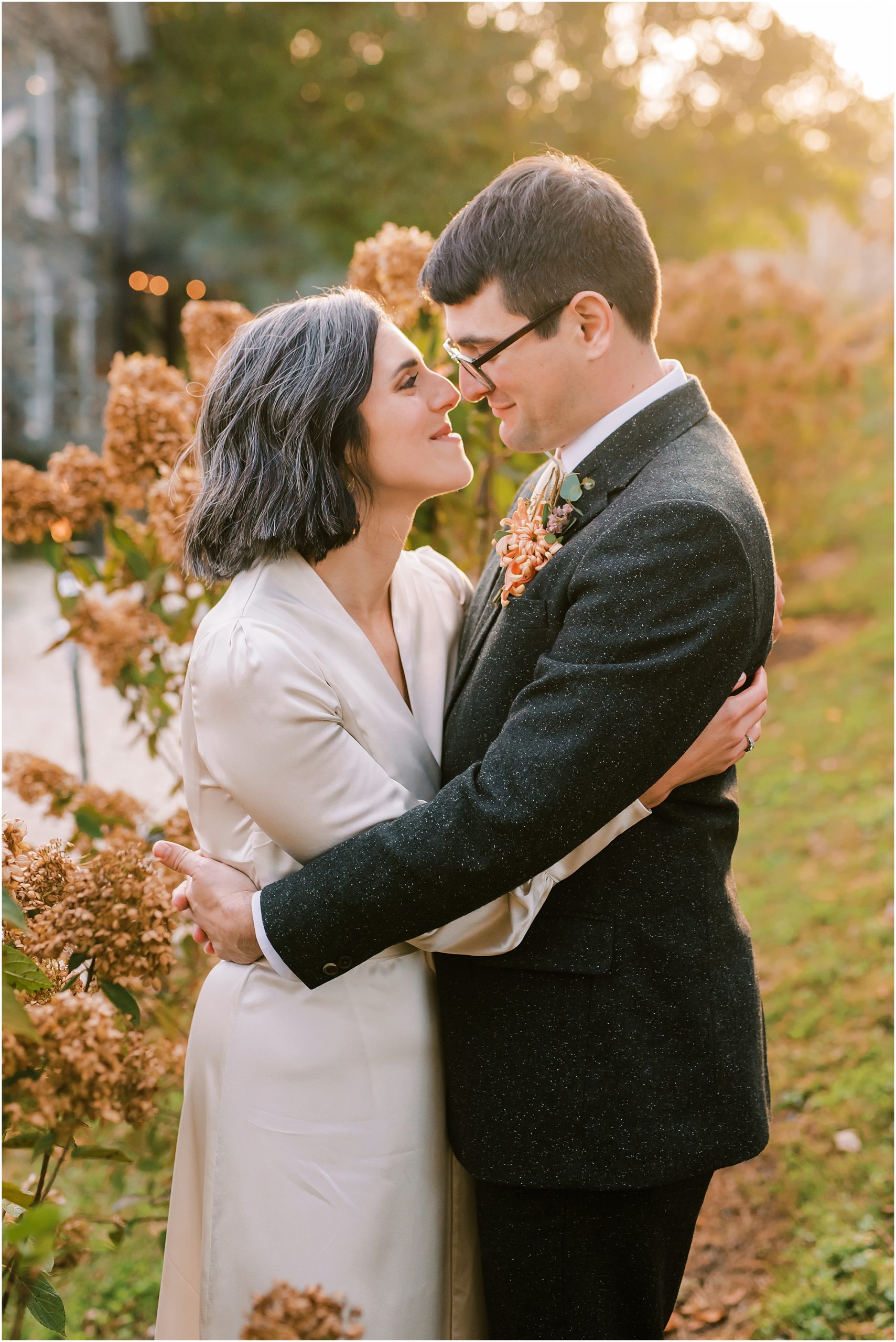 Newlyweds embracing during golden hour at Tranquility Farm