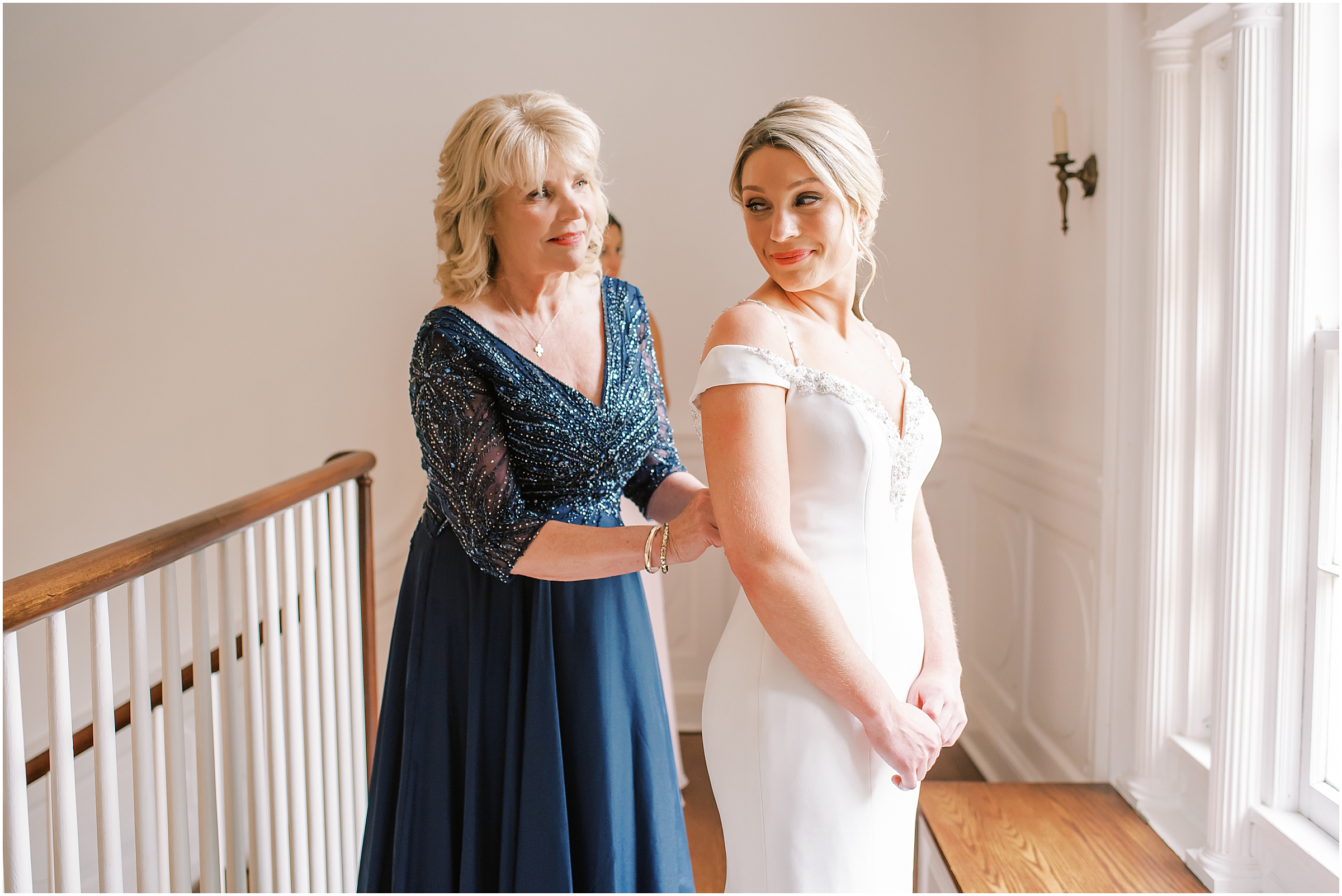 Mom helping bride get ready for wedding at Rust Manor House
