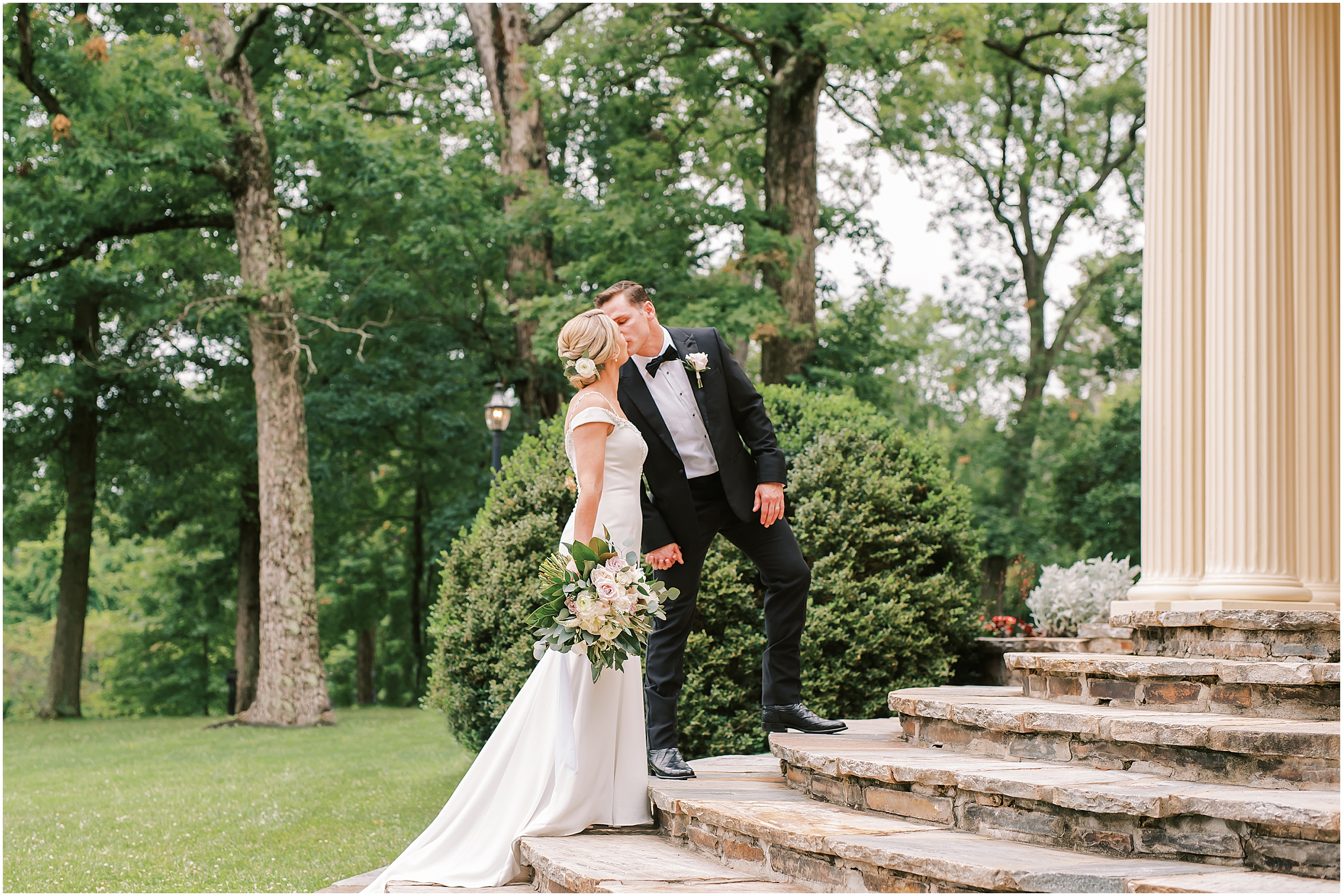 Bride and groom on steps of Rust Manor House