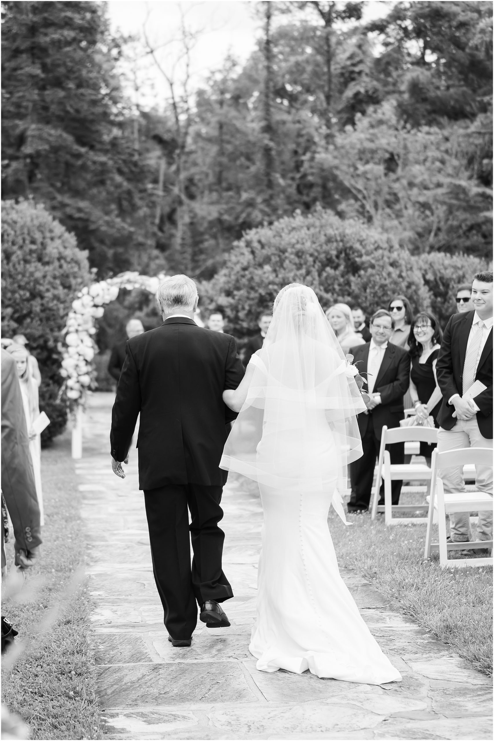 Bride and dad walking down wedding aisle