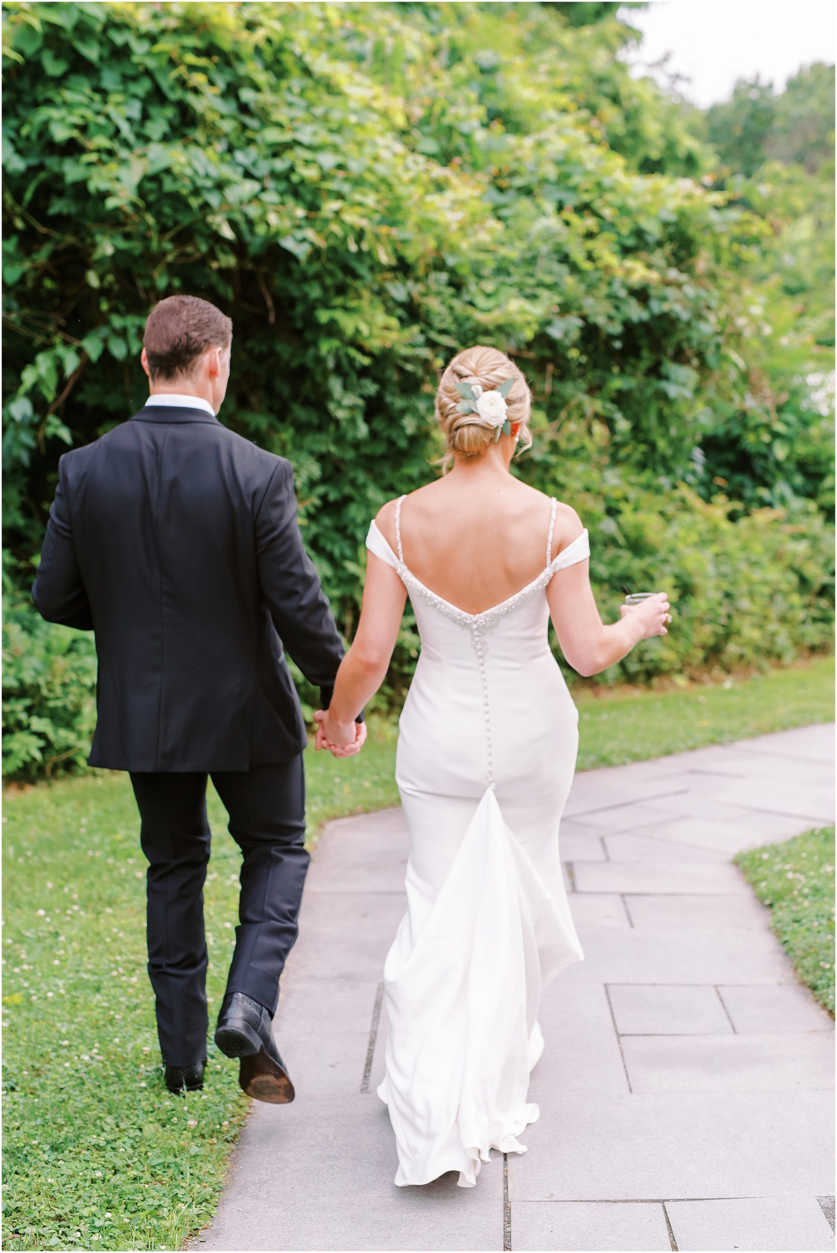 Bride and groom walking down path