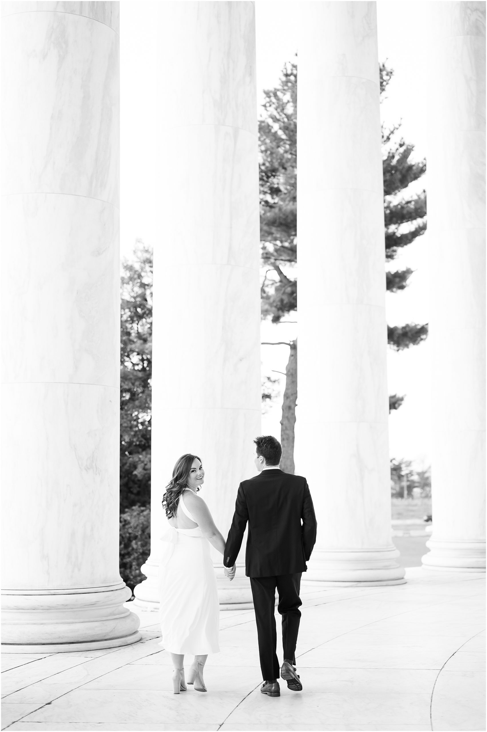 Couple walking through the Lincoln Memorial