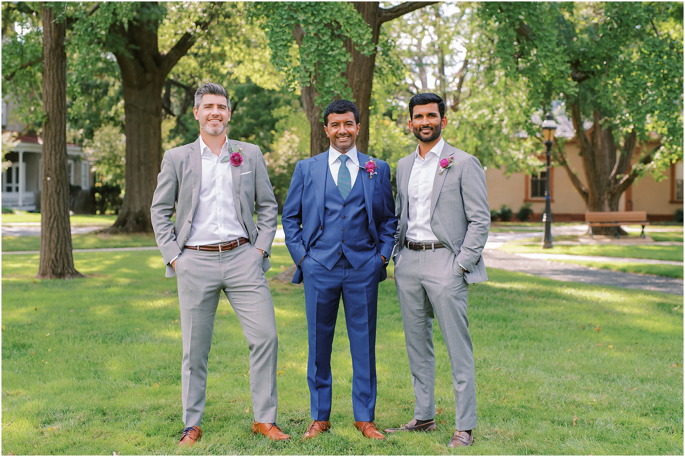 Groomsmen in grey suits with colorful boutonnières 