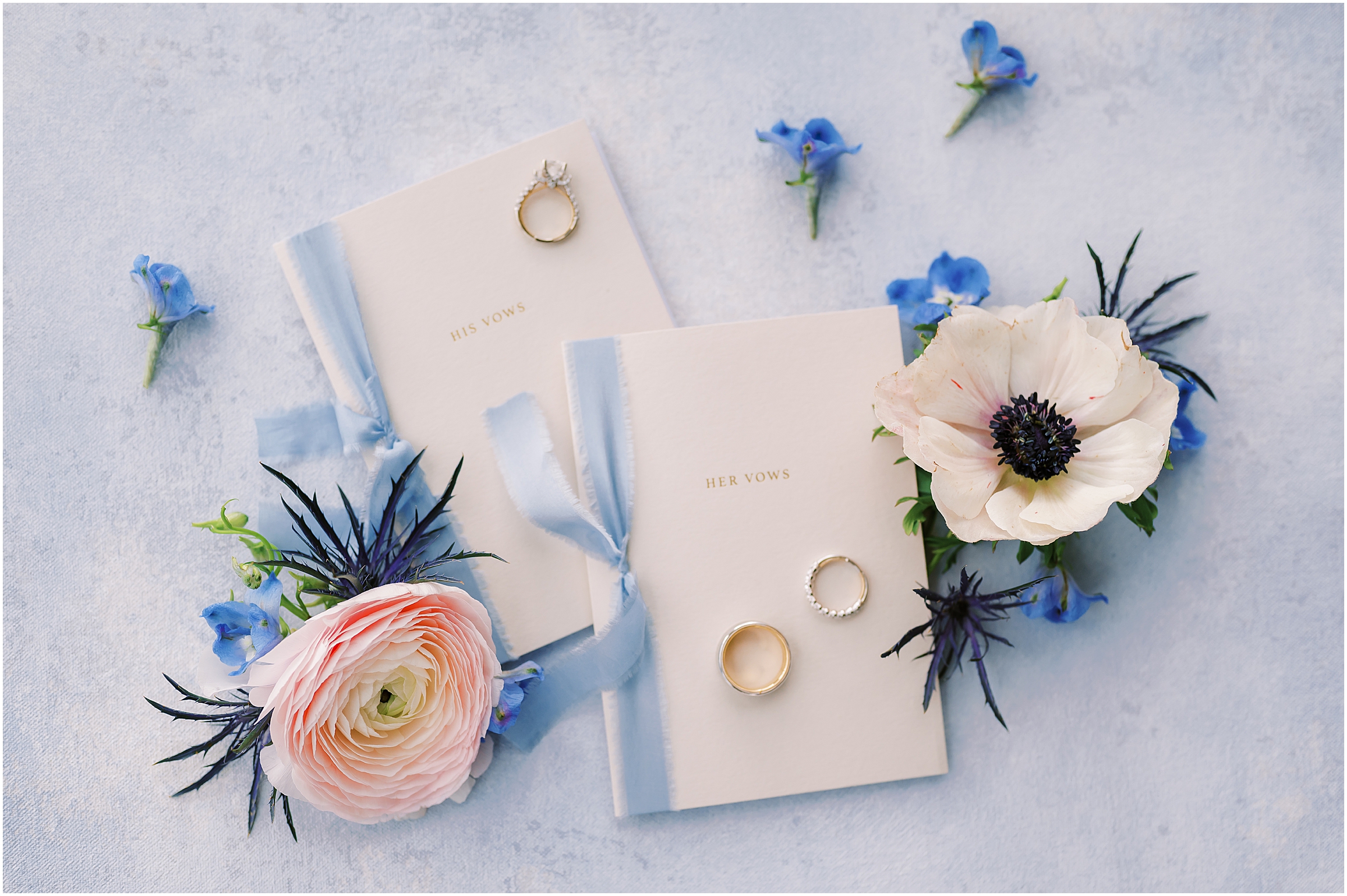 Wedding details - Rings and vow books with dusty blue ribbon