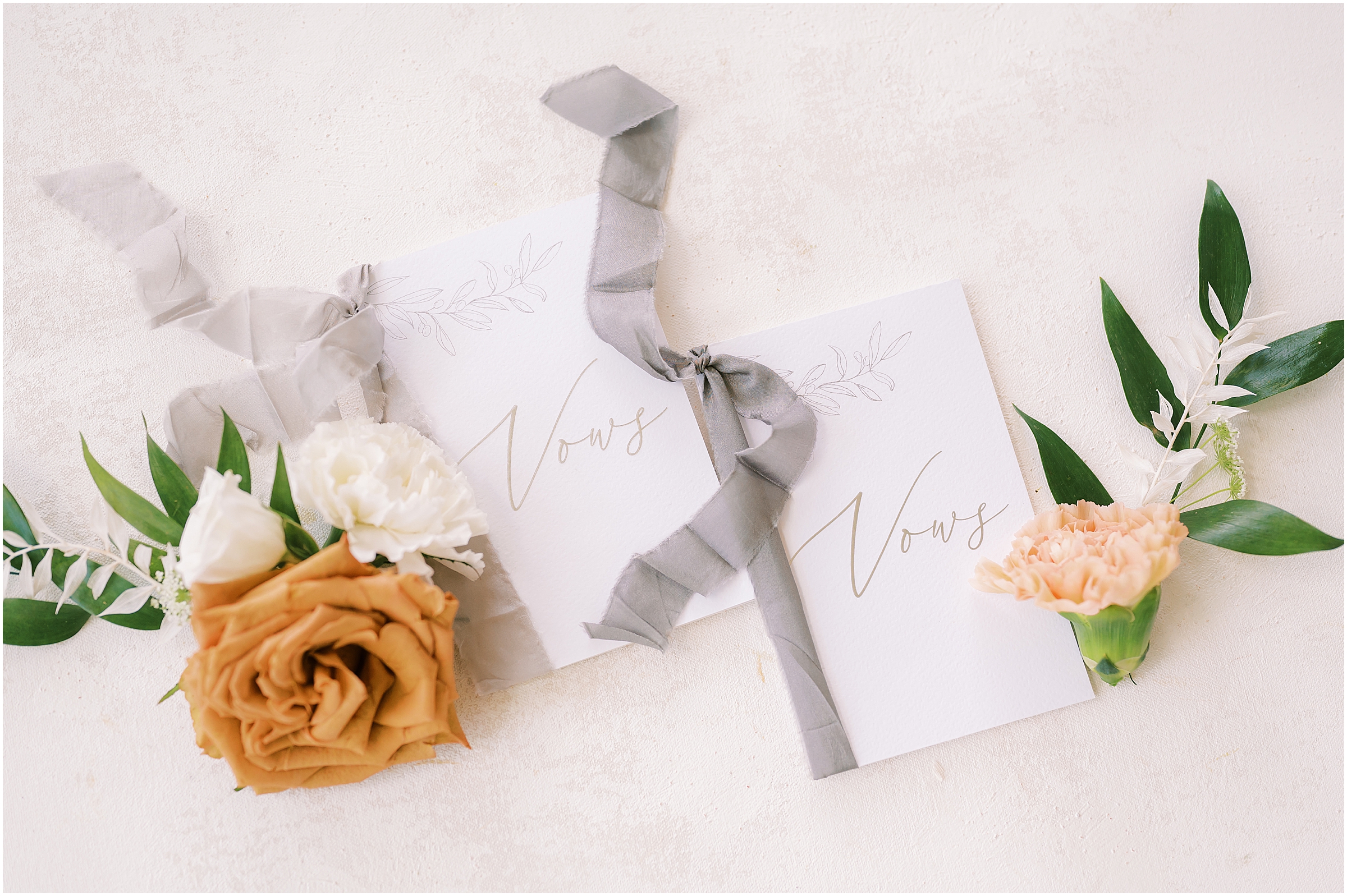 White vow books with grey ribbon
