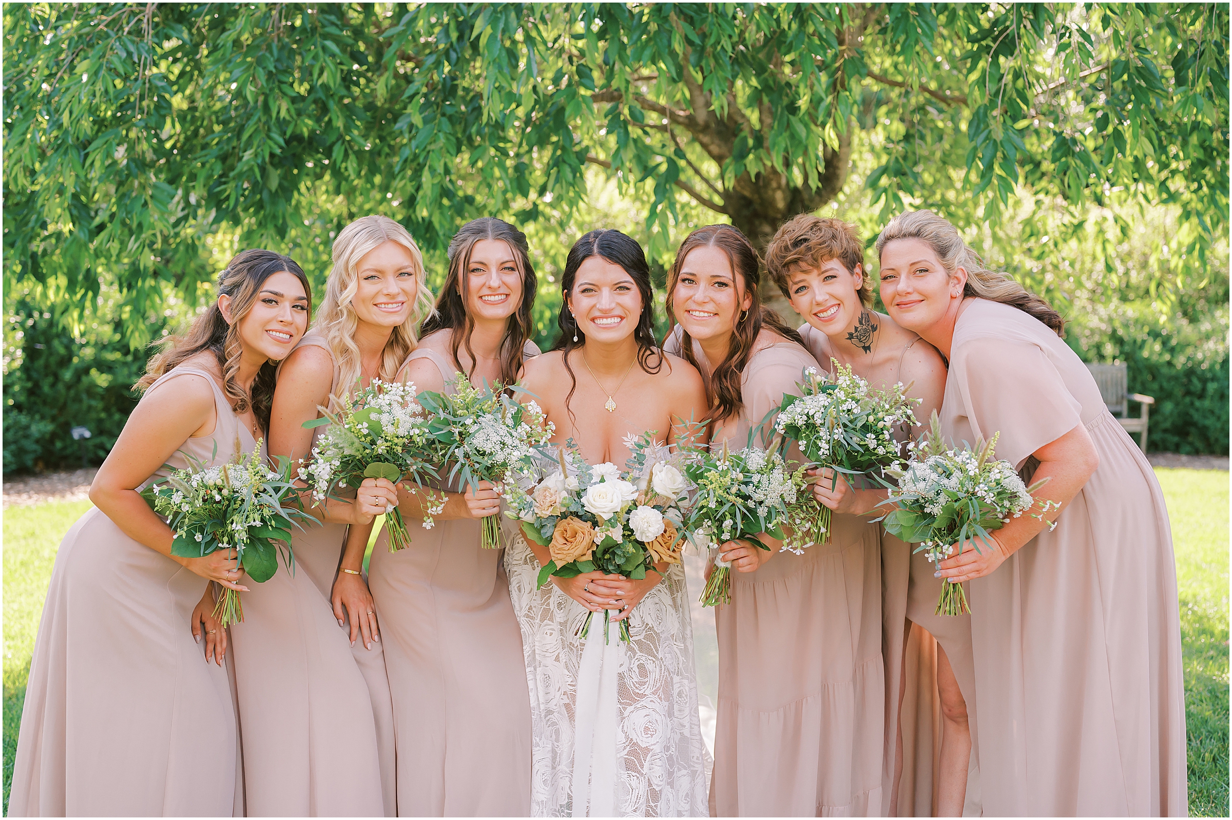 Bride and bridesmaids in blush pink bridesmaid dresses