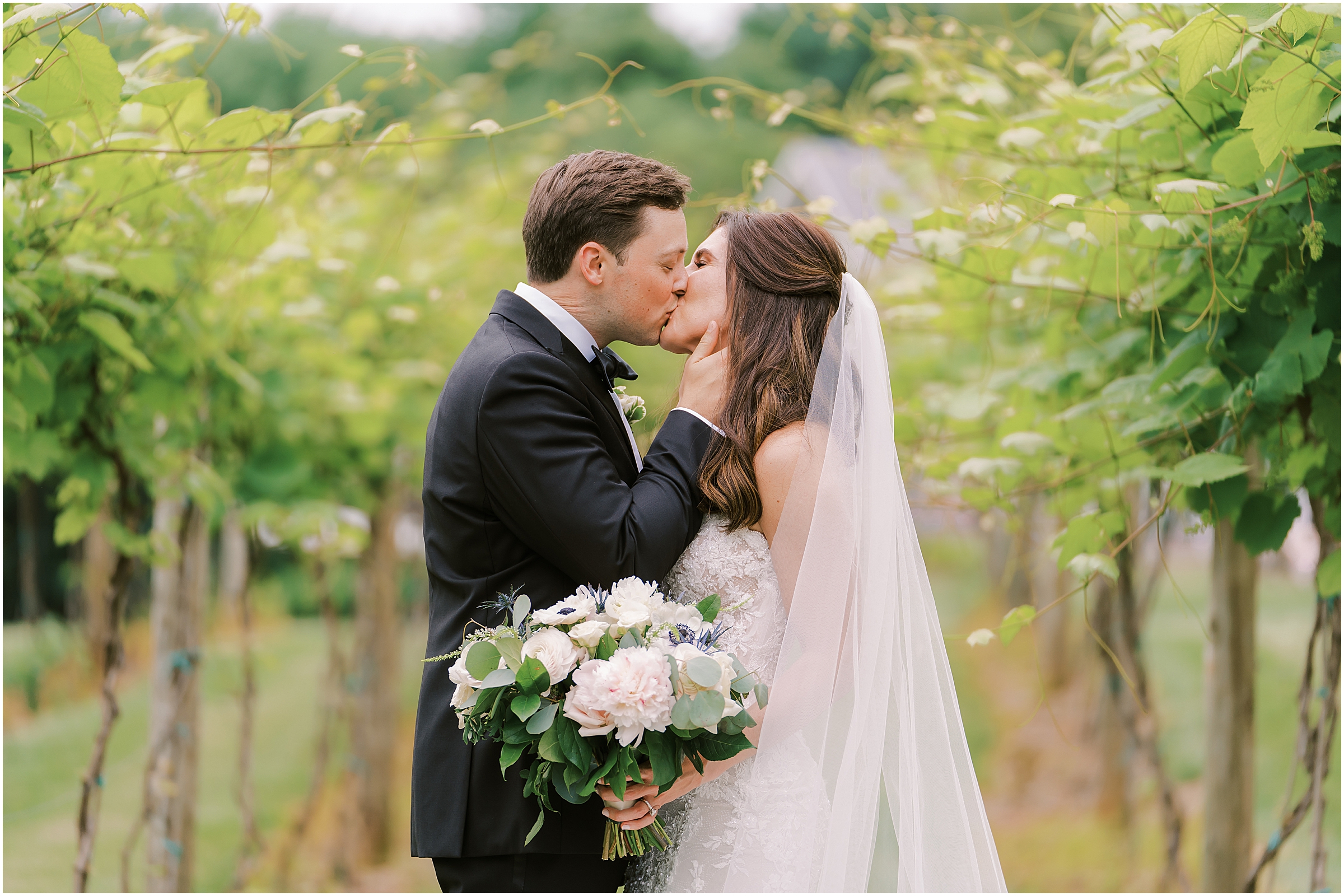 Bride and groom share a kiss at Fleetwood Farm Winery in Leesburg, VA